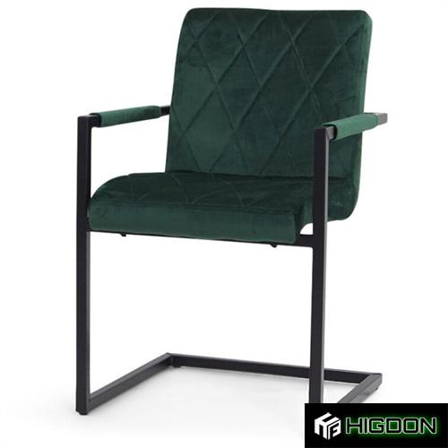 Dark green velvet dining chair with armrest