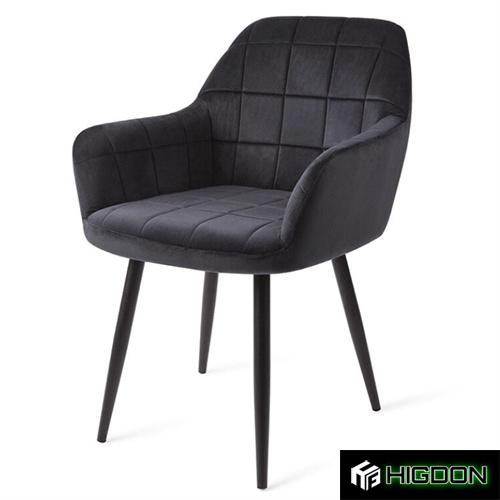 Luxurious black velvet armchair with sleek metal feet