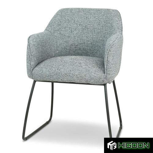 Grey fabric armchair with a sleek metal base