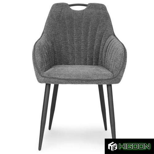 comfortable grey upholstered armchair with sleek metal legs