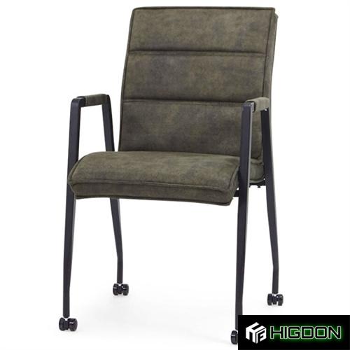 Dark green upholstered armchair on wheels