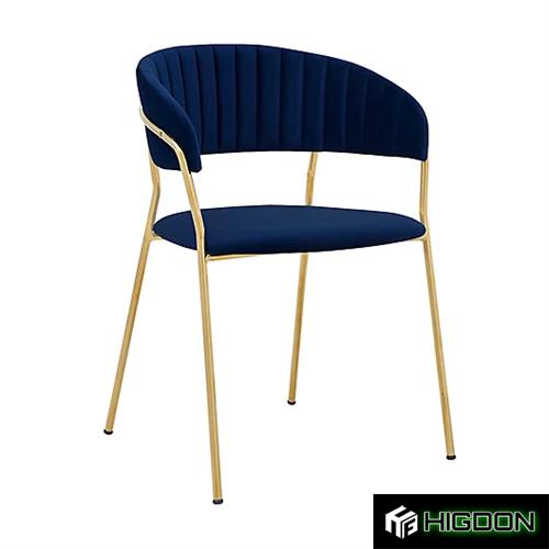 Luxurious navy blue velvet armchair with golden metal feet