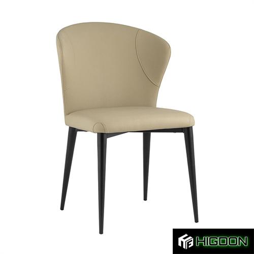 Beige faux leather dining seat with black metal feet