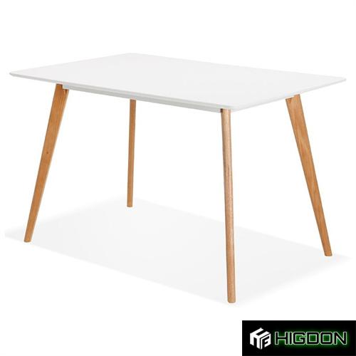 White rectangular dining table with an MDF top and wood feet