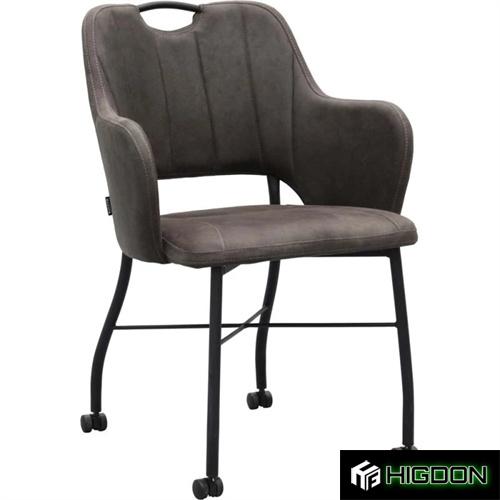 Dark grey upholstered armchair on wheels