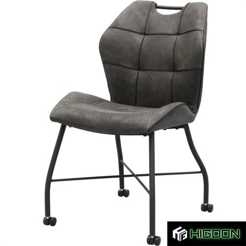 Dark grey upholstered dining chair on wheels