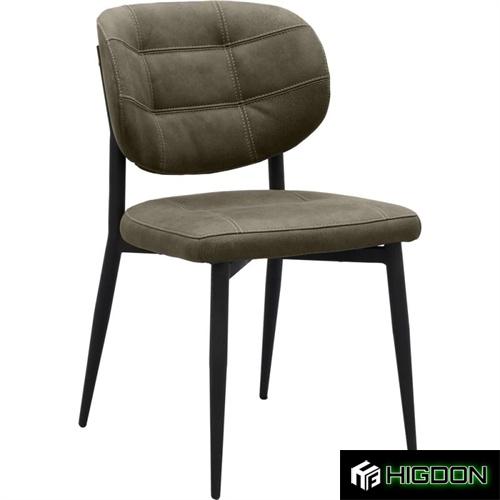 Deep green upholstered dining chair with metal feet