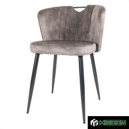 Dining chair with its warm grey velvet seat and metal feet