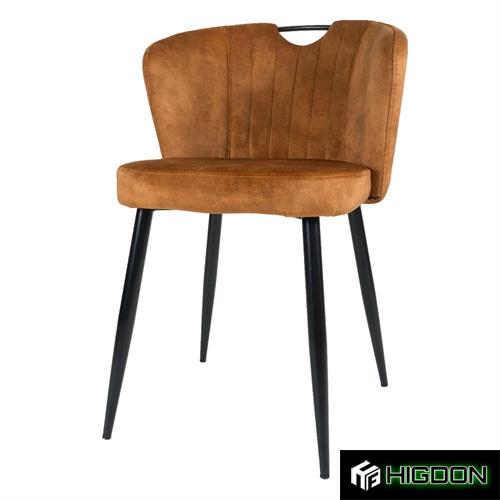  Dining chair with its brownish yellow fabric seat and sleek metal feet