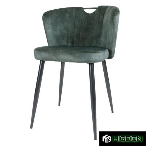 Deep green dining chair with its fabric seat and metal feet 