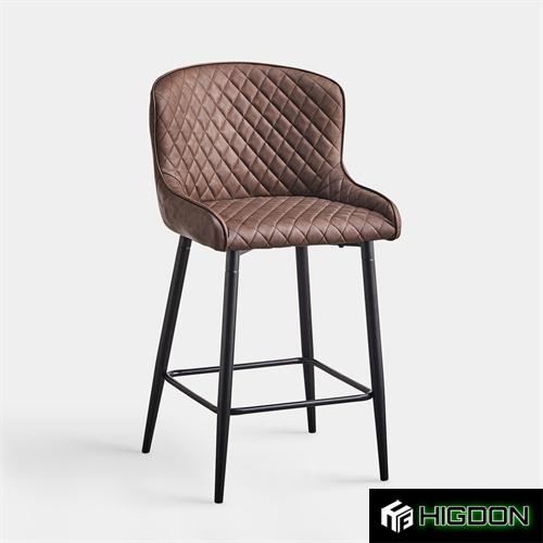 Brown upholstered bar stool with metal feet